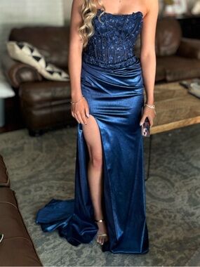 Metallic Blue Prom dress sized 0 worn once. Excellent condition. Corset bodis.